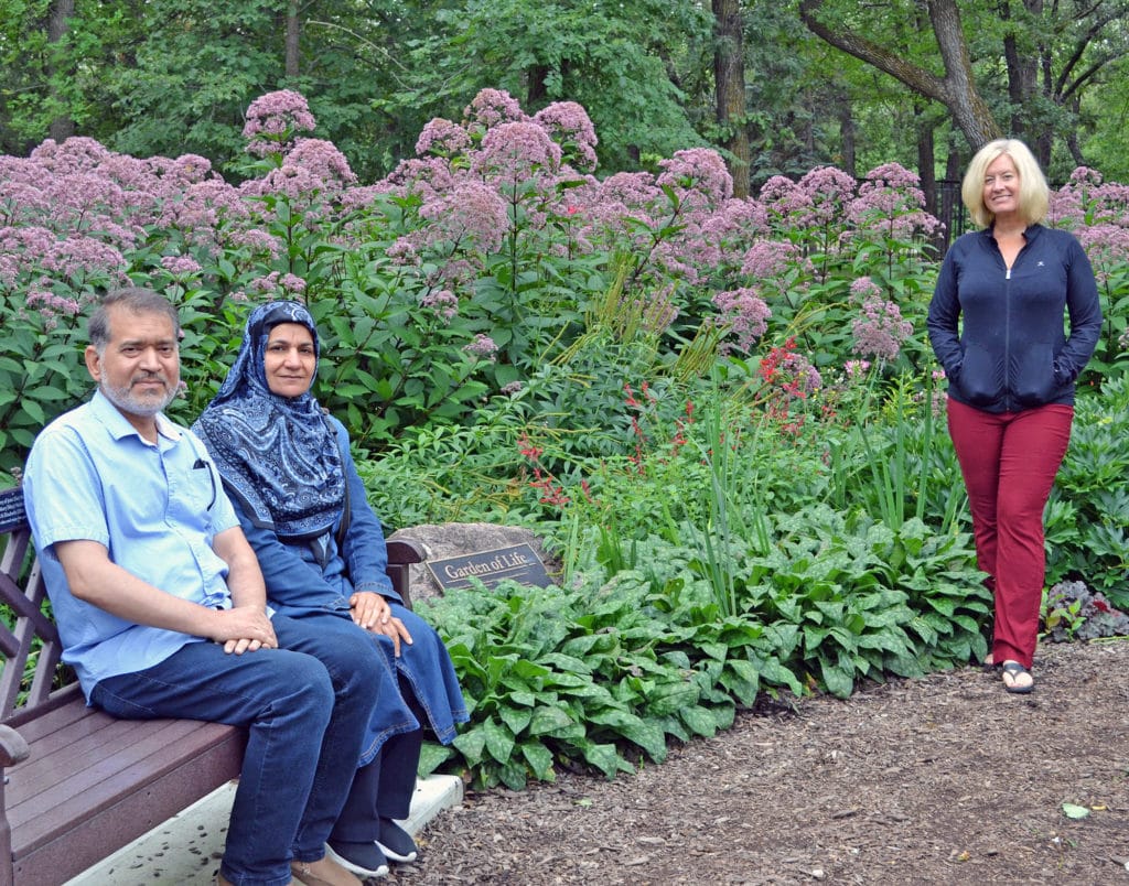 Saad and Amel Abdulrasool with Abdulrasool's living donor, Tracey Craigon amongst flowers at the Garden of Life.